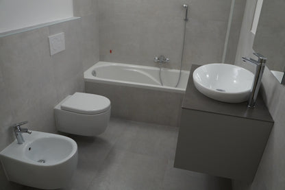 Renovare baie modernă cu sanitare suspendate și cadă
